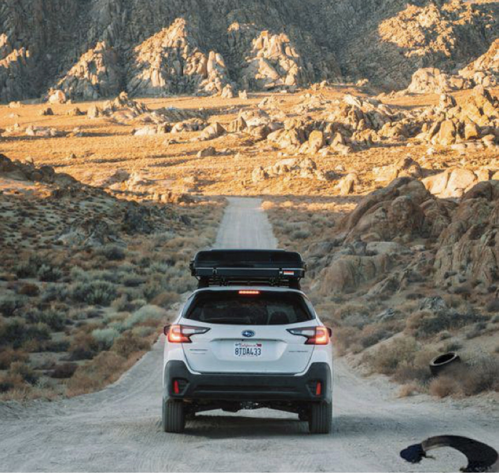 Subaru driving down desert road