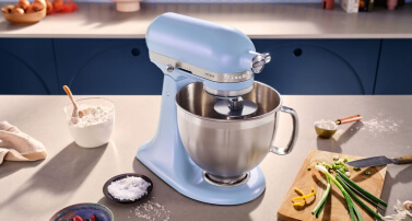 Photo of Blue Salt Stand Mixer on countertop surrounded by ingredients